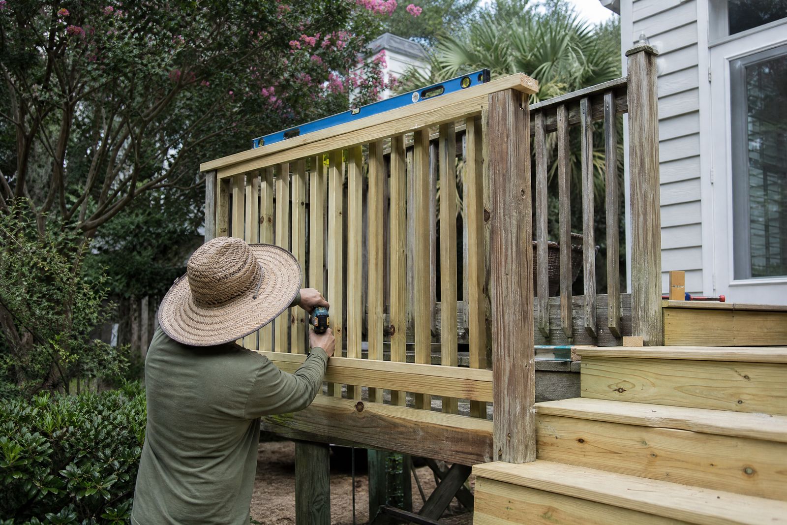 Railing & Stair Repair in Charleston, SC: new deck railing balusters and stair treads being installed on a Charleston deck
